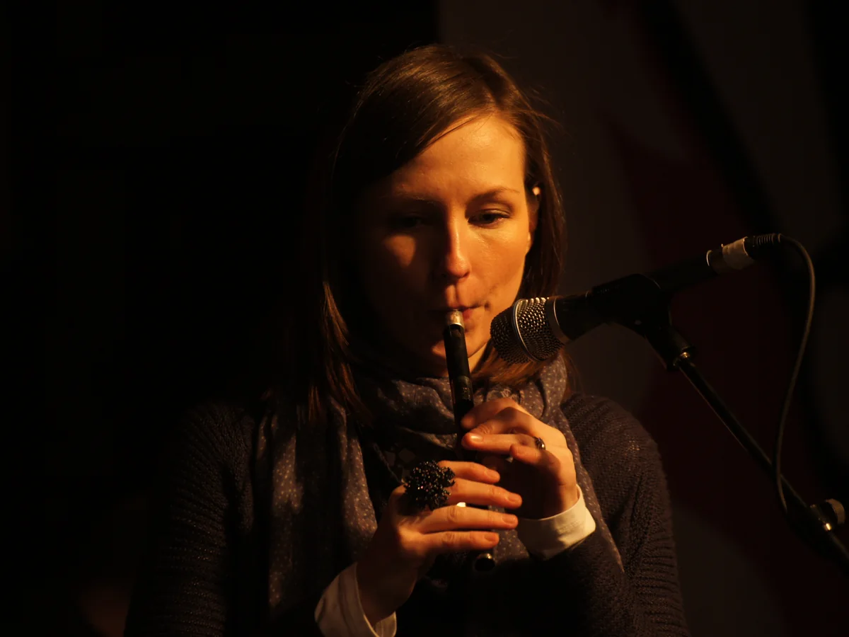 A musician performing on a lit stage in Edinburgh